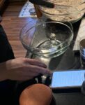 Picture of user using phone to follow recipe while cooking